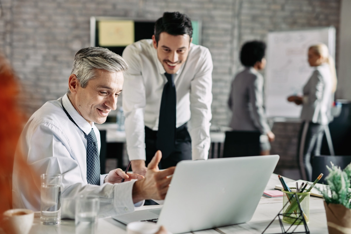 Three people standing by a desk